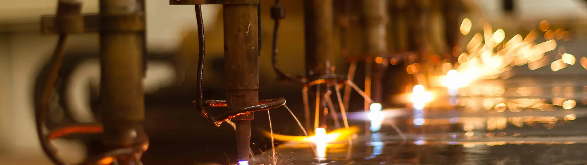 Industrial welding sparks against a workshop floor